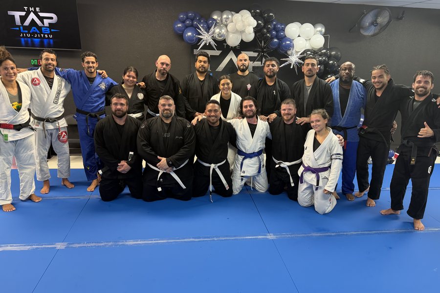 Adult students and instructors of The Tap Lab together on the mats after class