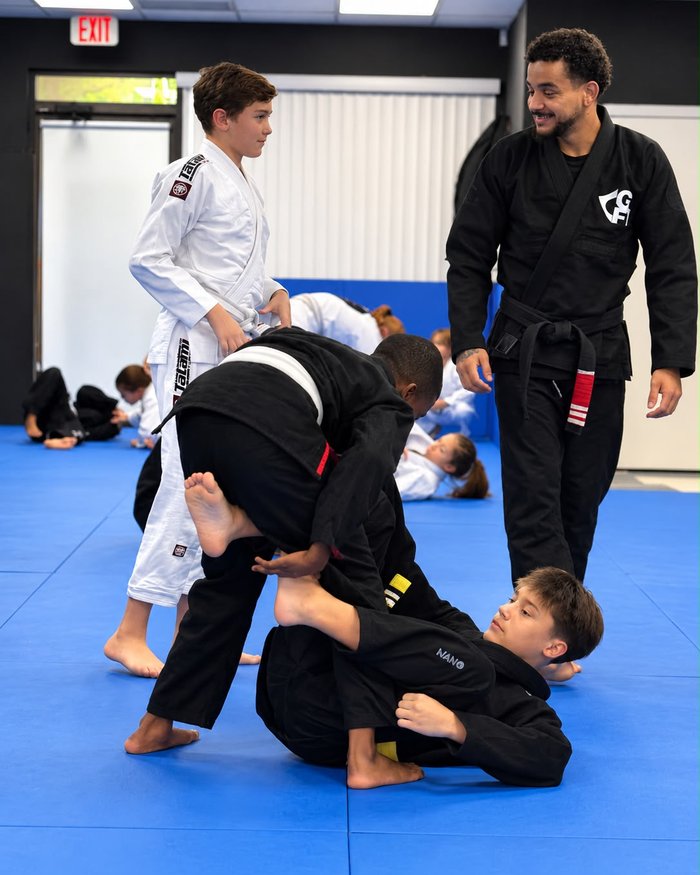 Kids drilling in the gi at The Tap Lab while head instructor Cauat&atilde; Samuel watches